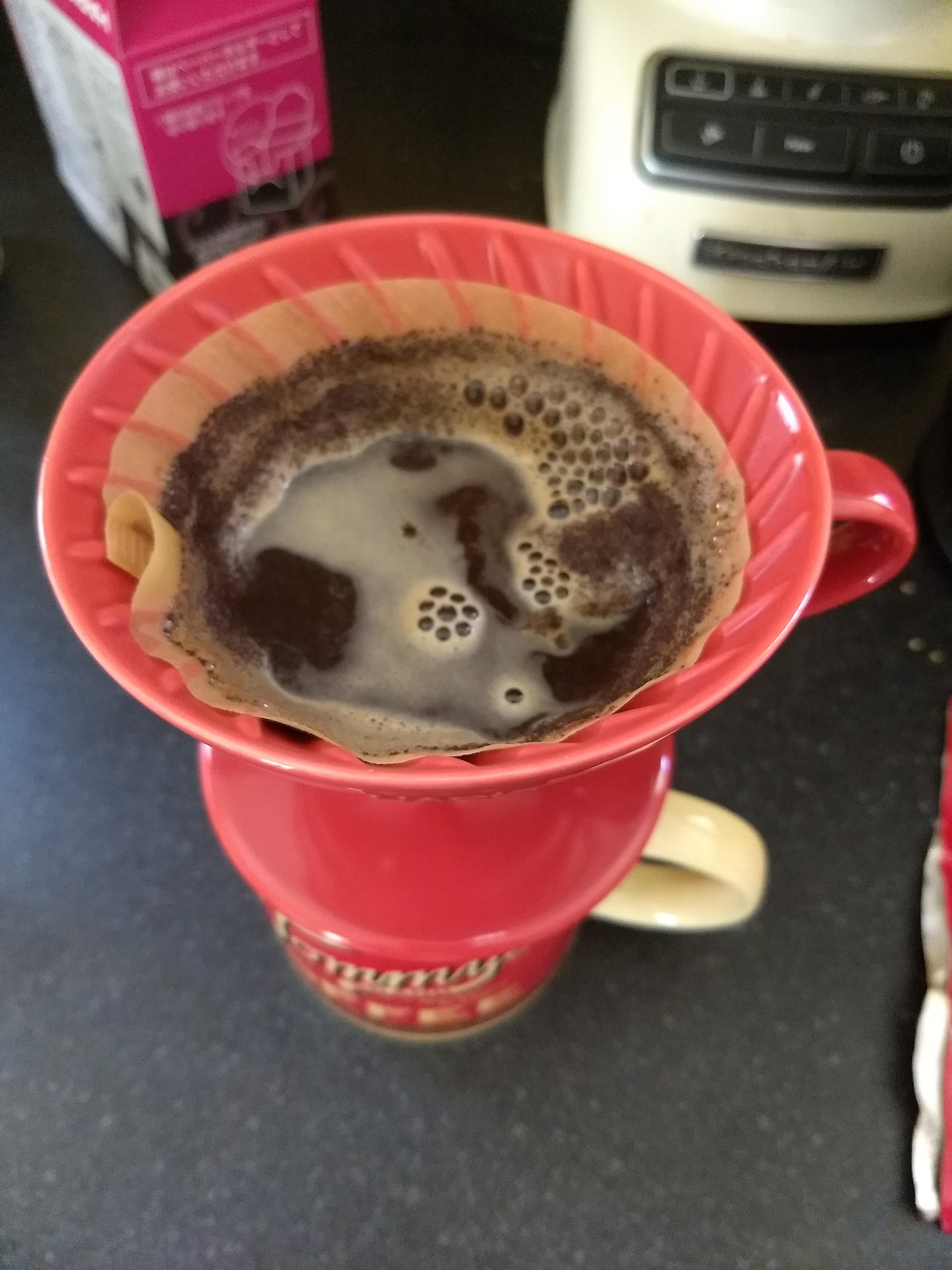 A Hario V60 coffee dripper being used
